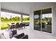 Spacious covered patio, overlooks serene backyard and lake at 10009 Zennia Ln, Parrish, FL 34219