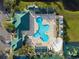 Aerial view of community pool, playground, and clubhouse at 1931 Sassafras Dr, Wesley Chapel, FL 33543