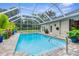 Beautiful screened pool with paver deck and tropical landscaping at 426 Romine Ct, Spring Hill, FL 34609