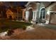 Well-lit home exterior with attractive landscaping and brick driveway at 10441 Garda Dr, Trinity, FL 34655