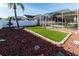 Landscaped backyard with putting green and fountain at 12528 Roseland Dr, New Port Richey, FL 34654
