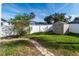 Backyard with stone path, shed, and fenced area at 12528 Roseland Dr, New Port Richey, FL 34654