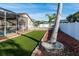 Backyard with artificial turf, palm tree, and pool in background at 12528 Roseland Dr, New Port Richey, FL 34654