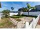 Backyard with stone pathway, shed, and fenced enclosure at 12528 Roseland Dr, New Port Richey, FL 34654