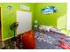 Bedroom with lime green walls, double closets, and wood-look floors at 12528 Roseland Dr, New Port Richey, FL 34654