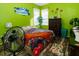 Bedroom with lime green walls, wood-look floors, and a comfortable bed at 12528 Roseland Dr, New Port Richey, FL 34654