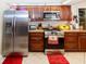 Modern kitchen features stainless steel appliances and wood cabinetry at 12528 Roseland Dr, New Port Richey, FL 34654