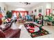 Spacious living area with a large TV, comfortable seating, and tiled floors at 12528 Roseland Dr, New Port Richey, FL 34654