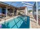 Sparkling swimming pool with covered patio at 12528 Roseland Dr, New Port Richey, FL 34654