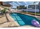 Relaxing screened-in pool with a floating ball at 12528 Roseland Dr, New Port Richey, FL 34654