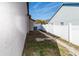 Side yard with stone path and white fence at 12528 Roseland Dr, New Port Richey, FL 34654