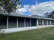Back exterior view of home with screened lanai at 10516 Moshie Ln, San Antonio, FL 33576