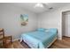 Bedroom with light blue bedding, wood floors and coastal art at 10516 Moshie Ln, San Antonio, FL 33576