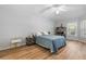 Spacious bedroom with light blue bedding and wood floors at 10516 Moshie Ln, San Antonio, FL 33576