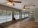 Sunroom with wood-look floors, sliding doors and ceiling fans at 10516 Moshie Ln, San Antonio, FL 33576