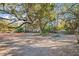 Cleared building lot with large oak tree providing shade at 2303 S Hesperides St, Tampa, FL 33629