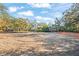 Cleared lot ready for new construction, surrounded by mature trees at 2303 S Hesperides St, Tampa, FL 33629