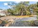Cleared lot with circular driveway and surrounding trees at 2303 S Hesperides St, Tampa, FL 33629