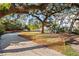 Driveway entrance to cleared lot with mature trees at 2303 S Hesperides St, Tampa, FL 33629