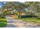 Landscaped lot entrance with mature trees and hedges at 2303 S Hesperides St, Tampa, FL 33629