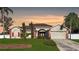 Brick one-story home with attached garage, landscaping, and large yard at 12289 Glen Haven St, Spring Hill, FL 34609