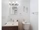 Small bathroom with sink, toilet, and decorative seahorses at 12637 2Nd Isle, Hudson, FL 34667