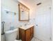 Updated bathroom with wood vanity, medicine cabinet, and toilet at 12637 2Nd Isle, Hudson, FL 34667