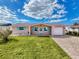 Quaint house with teal door and shutters, plus a brick-paver driveway at 12637 2Nd Isle, Hudson, FL 34667