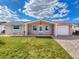 Charming one-story home with teal accents and a brick paver driveway at 12637 2Nd Isle, Hudson, FL 34667