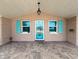 Covered porch with teal door and light fixture at 12637 2Nd Isle, Hudson, FL 34667