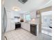 Modern white kitchen with stainless steel appliances and a breakfast bar at 12637 2Nd Isle, Hudson, FL 34667