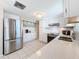 Modern kitchen featuring white cabinets and quartz countertops at 12637 2Nd Isle, Hudson, FL 34667