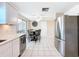 Eat-in kitchen with stainless steel refrigerator and breakfast area at 12637 2Nd Isle, Hudson, FL 34667