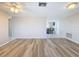 Open living room with wood-look floors, leading to the kitchen and dining area at 12637 2Nd Isle, Hudson, FL 34667