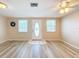 Bright living room featuring light wood-look floors and neutral walls at 12637 2Nd Isle, Hudson, FL 34667
