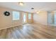 Bright living room featuring light wood-look floors and neutral walls at 12637 2Nd Isle, Hudson, FL 34667