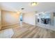 Open living room with wood-look floors, leading to the kitchen and dining area at 12637 2Nd Isle, Hudson, FL 34667