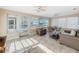 Bright sunroom with water views and multiple ceiling fans at 12637 2Nd Isle, Hudson, FL 34667