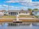 Backyard with patio, screened porch, and private dock at 12637 2Nd Isle, Hudson, FL 34667