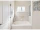 Simple bathroom with a shower/tub combo and window at 18134 Powerline Rd, Dade City, FL 33523