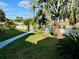 Relaxing waterfront backyard with walkway and tropical plants at 1354 Linstock Dr, Holiday, FL 34690