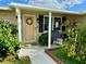 Inviting front porch with decorative wreath and hanging planters at 1354 Linstock Dr, Holiday, FL 34690