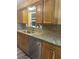 Modern kitchen with granite countertops and stainless steel dishwasher at 1354 Linstock Dr, Holiday, FL 34690