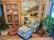 Living area showcasing a stylish armchair, ottoman, and decorative cabinet at 1354 Linstock Dr, Holiday, FL 34690
