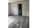 Bedroom with vinyl flooring and access to the bathroom at 1925 Patriot Ln, Holiday, FL 34690