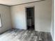 Spacious bedroom with vinyl flooring and access to the bathroom at 1925 Patriot Ln, Holiday, FL 34690