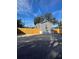 Single-wide manufactured home with wood fence and gravel driveway at 1925 Patriot Ln, Holiday, FL 34690