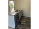 Kitchen island with double sink, granite countertop, and dishwasher at 1925 Patriot Ln, Holiday, FL 34690