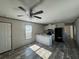 Open living room and kitchen with vinyl flooring and ceiling fan at 1925 Patriot Ln, Holiday, FL 34690