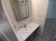 Tiled bathroom featuring a white sink and vanity at 7552 Cumber Dr, New Port Richey, FL 34653